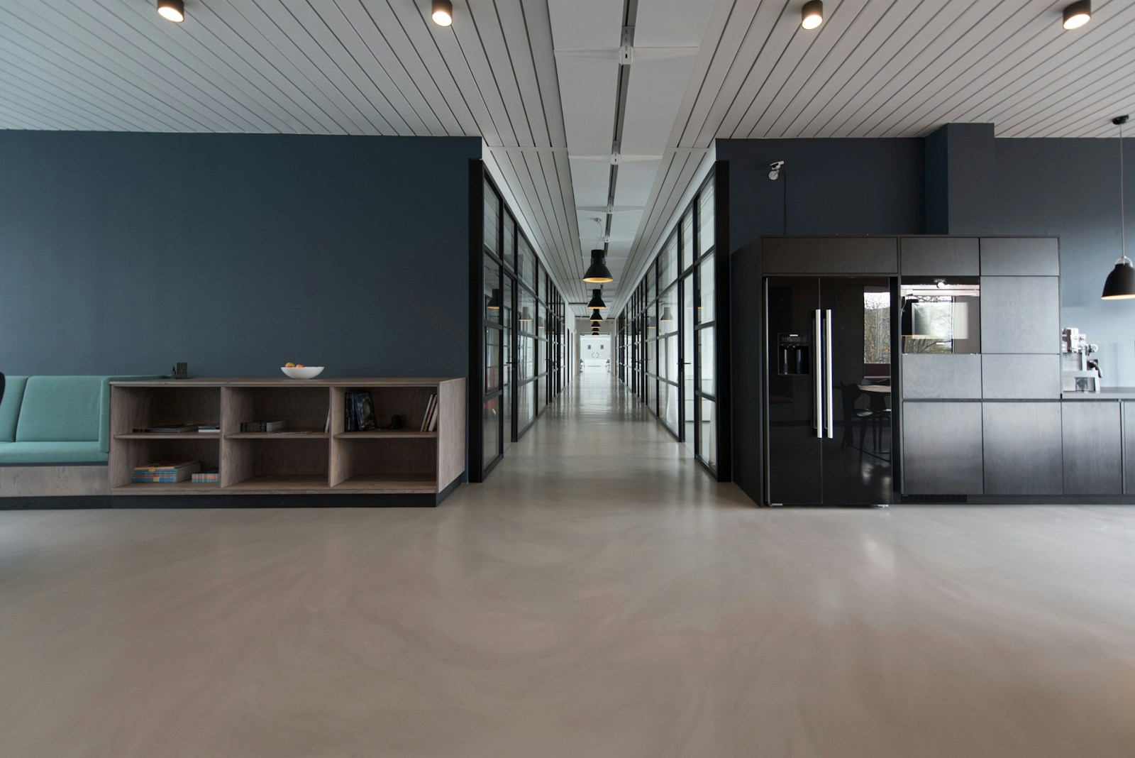 Evening studio corridor — the quiet after a briefing, before the next print mark.